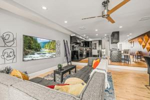 a living room with a couch and a tv at 5 bdrm - Heated Indoor Pool - Roof Top Deck in Philadelphia