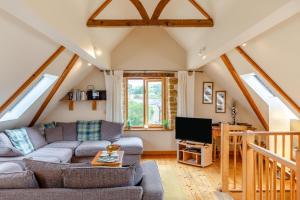 a living room with a couch and a tv at 2 Bed in Bridport oc-dc111 in Chideock