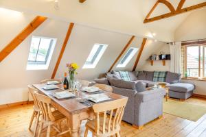 a living room with a table and a couch at 2 Bed in Bridport oc-dc111 in Chideock