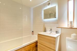 a white bathroom with a sink and a shower at 2 Bed in Bridport oc-dc111 in Chideock +16 photos