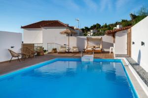 a swimming pool on the roof of a house at Galini Hellenic Hospitality in Patitiri