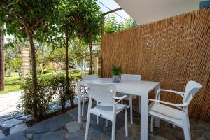a white table and chairs on a patio at Lemon Garden Apartments in Lygia