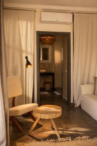 a living room with a couch and a table at Casa Lalla Hotel Rural in Douar Aguergour