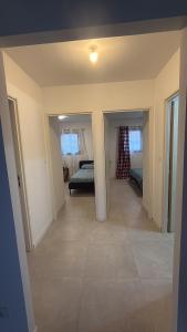 a hallway of a house with a bedroom and a bed at Porte de la Méditerranée in Perpignan