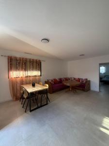 a living room with a table and a couch at Porte de la Méditerranée in Perpignan