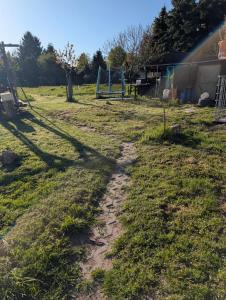a dirt path in a field with a playground at Natur Camping Rabu in Radeburg
