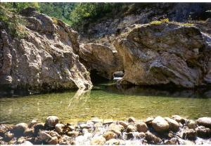 a pool of water with rocks in a river at Il Vicolo in Cagli