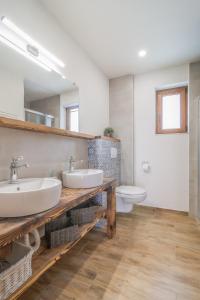 a bathroom with two sinks and a toilet at Modrý Dom - Telgárt Resort in Telgárt