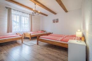 a bedroom with two beds and a window at Modrý Dom - Telgárt Resort in Telgárt
