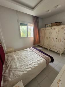 a bedroom with a large bed and a window at Waterfront house 1 in Kelibia