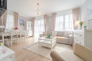 a living room with a couch and a table at Apartament Prowansalski in Nałęczów