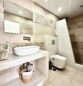 a bathroom with a sink and a toilet at Giasemi Fira Studios in Fira