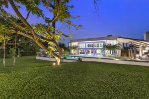a house with a large lawn in front of it at Luxury 9-Bedroom Villa in Southwest Ranches with Private Pool, Jacuzzi, and Movie Theater, Sleeps 20 in Miami