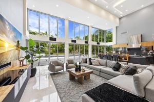 a living room with a couch and a table at Luxury 9-Bedroom Villa in Southwest Ranches with Private Pool, Jacuzzi, and Movie Theater, Sleeps 20 in Miami