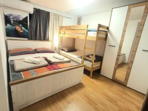 a bedroom with two bunk beds and a mirror at UNIQUE Apartments Malinska in Malinska