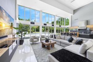 a living room with a lot of windows at Luxury 9-Bedroom Villa in Southwest Ranches with Private Pool, Jacuzzi, and Movie Theater, Sleeps 20 in Miami +82 photos