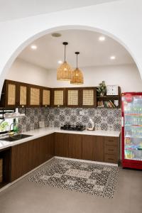 a kitchen with a counter and a refrigerator at Lacasa Homestay in Hue
