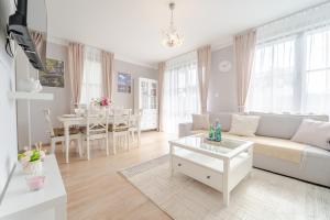 a living room with a couch and a table at Apartament Prowansalski in Nałęczów