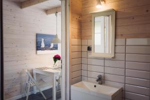 a small bathroom with a table and a sink at Marynarskie Domki in Pobierowo +46 photos