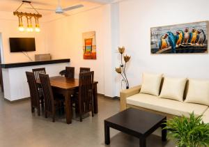 a living room with a table and a couch at Walawa Valley Rest Inn in Udawalawe
