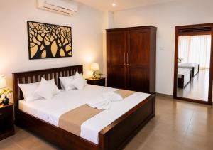 a bedroom with a large bed and a bathroom at Walawa Valley Rest Inn in Udawalawe +94 photos