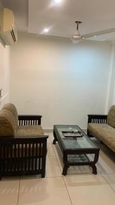 a living room with two chairs and a coffee table at narayana regency in Ludhiana
