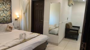 a small bedroom with a bed and a mirror at narayana regency in Ludhiana