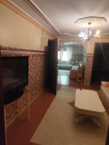 a living room with a television and a couch at Aroui aireport in Nador Airport