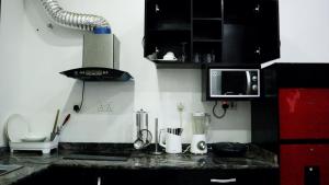 a kitchen with a counter top with a blender at JRC Chariot Luxury Apartment in Omole