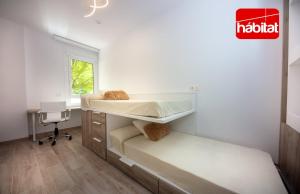 a bedroom with two bunk beds and a desk at Domus Halo D in Pamplona