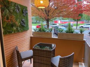 a patio with two chairs and a table and a window at Domus Halo D in Pamplona +3 photos