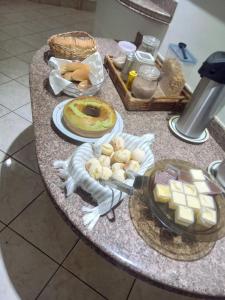 a table topped with food and a tray of food at Quefren Residence Hotel in Uberaba