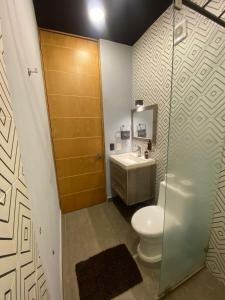 a bathroom with a toilet and a sink at REVU 519 in Tepic +95 photos