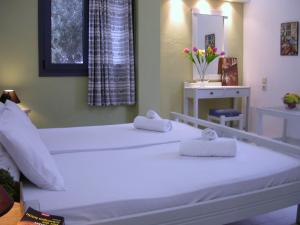Ліжко або ліжка в номері Terpsichori villa and apartments