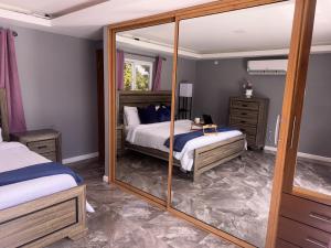 a bedroom with two beds and a mirror at Elegant 3-Bedroom Loft Condo in Kingston +37 photos