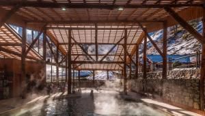 a pool of water in a building with a mountain at Depto Premium Ski-in Ski-out Edificio Alerces-Nevados de Chillán in Nevados de Chillan