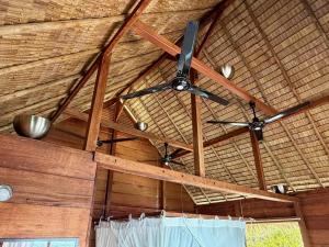 a ceiling with two fans in a room at ipyum Premium Overwater Guest House in Pulau Birie +13 photos