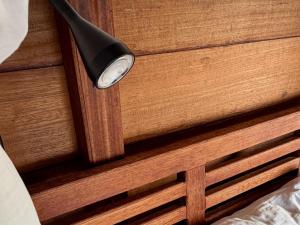 a light on the side of a wooden door at ipyum Premium Overwater Guest House in Pulau Birie