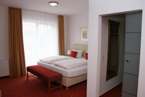Postel nebo postele na pokoji v ubytování Hotel Petersen