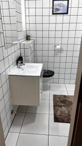 a white bathroom with a sink and a toilet at Sirály apartman in Keszthely +74 photos