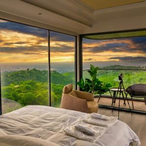 a bedroom with a bed and a large window at Sunny Home Park in Almaty