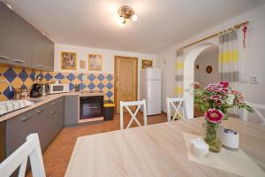 a kitchen with a table with a vase of flowers on it at Penzion Sv. Duch in Český Krumlov