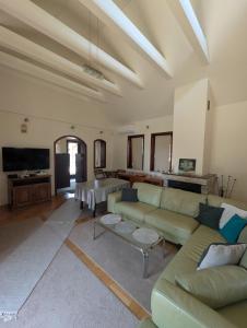 a living room with a couch and a table at Green Forest Resort Sarajevo in Sarajevo