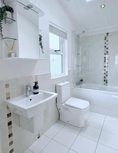 a bathroom with a sink and a toilet and a tub at Sea View Retreat Lodge in Heysham +59 photos