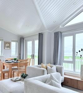 a living room with a couch and a table at Sea View Retreat Lodge in Heysham
