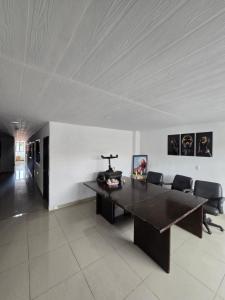 a large room with a table and chairs in it at Hotel Los Balcones in San Agustín