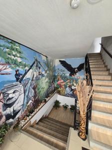 a mural on the side of a stairwell in a house at Hotel Los Balcones in San Agustín