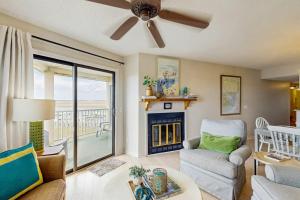 a living room with a couch and a fireplace at Bay Creek Villa - 311 in Edisto Beach