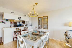 a kitchen and living room with a table and chairs at Bay Creek Villa - 311 in Edisto Beach