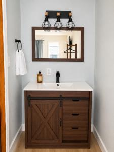 a bathroom with a sink and a mirror at Kiva Motel in Show Low
